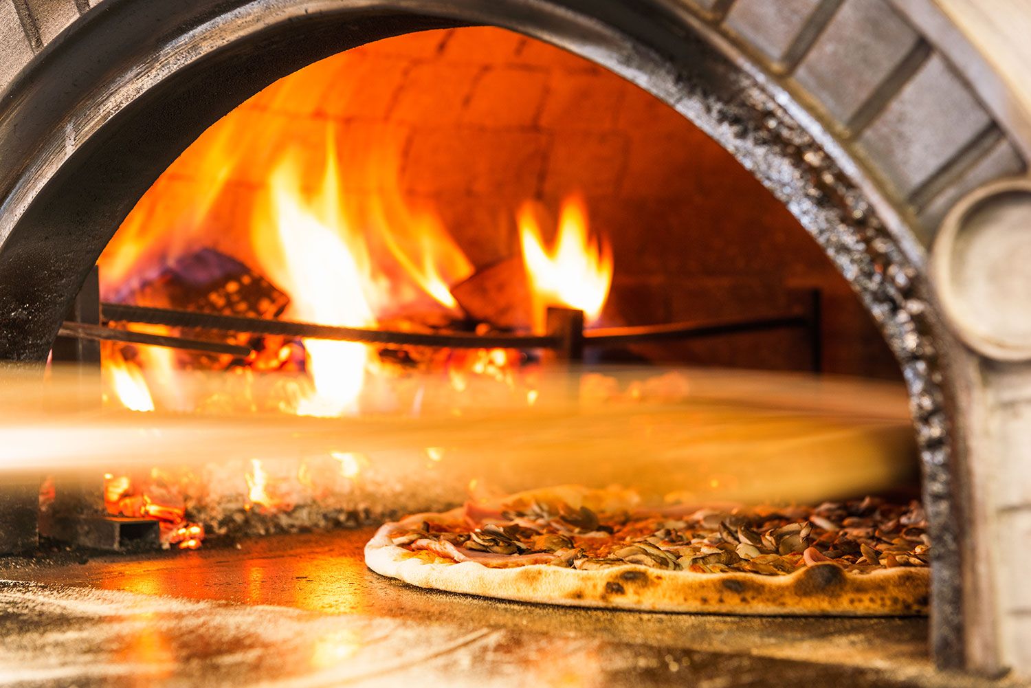 Making the pizza in a wood fired oven in Miami
